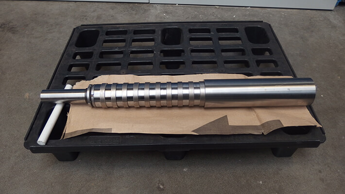 Shaft with ring-shaped samples for lab-scale rolling trials.